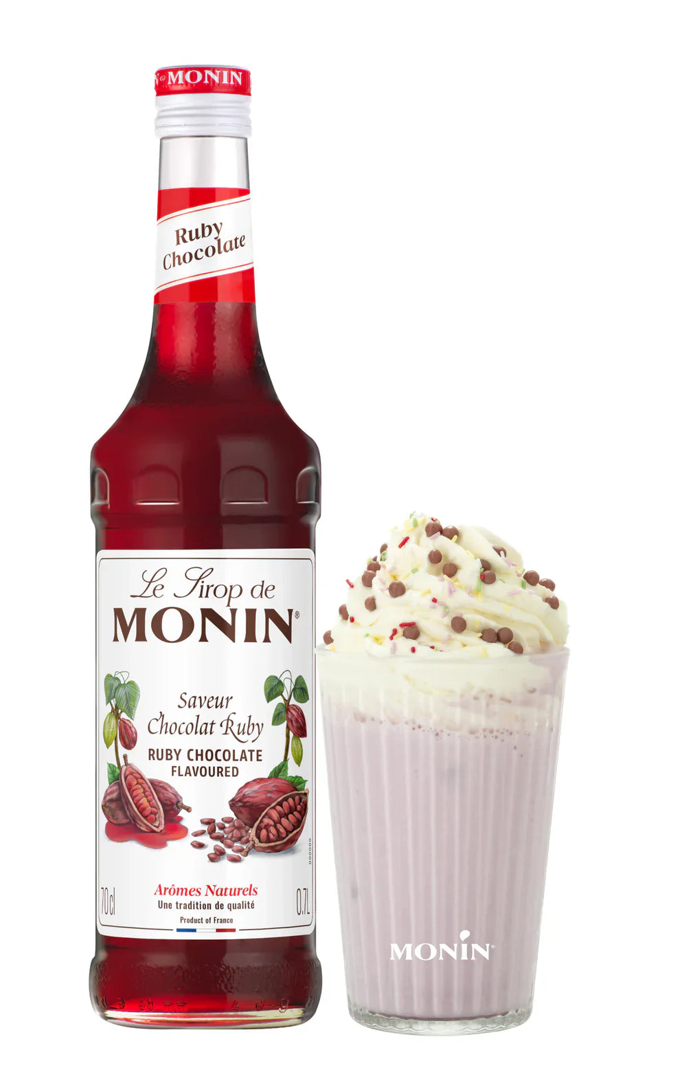Ruby Chocolate Monin syrup bottle beside ruby hot chocolate drink with whipped cream and sprinkles