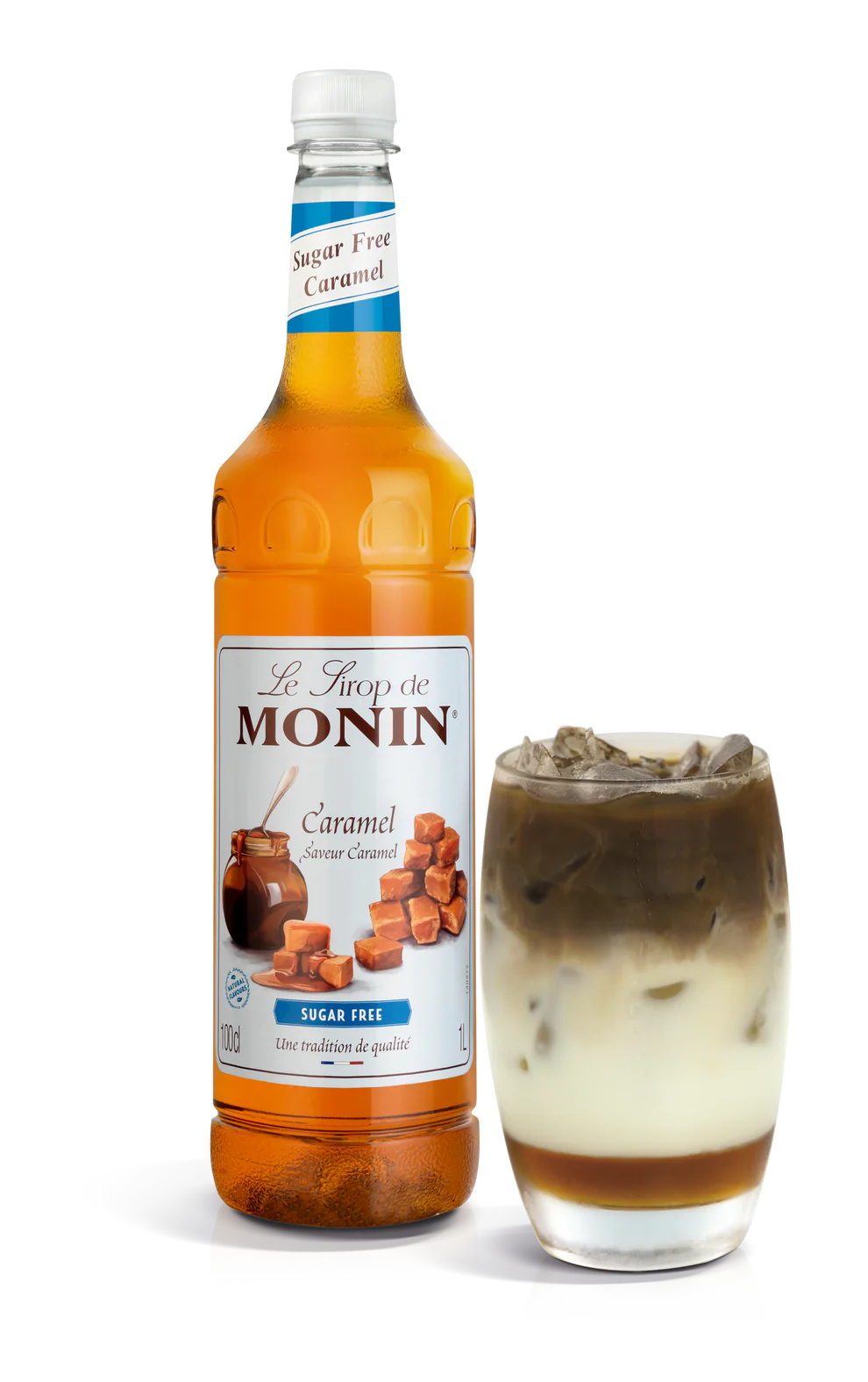 A bottle of Monin Sugar Free Caramel Syrup alongside a glass with syrup-drizzled dessert.